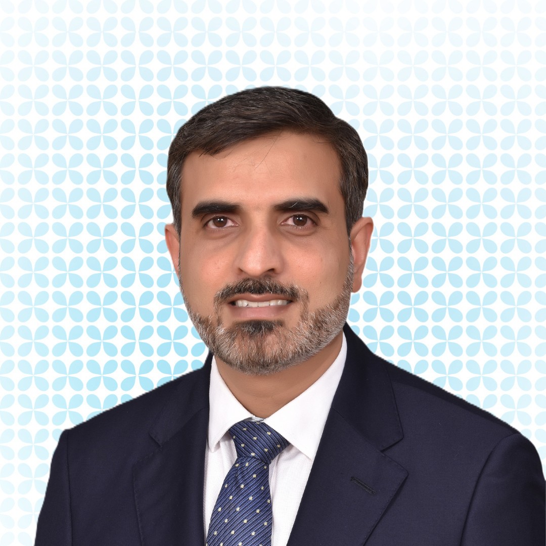 Portrait image of a Dr. Muhammad Amjad in dark suit and tie
