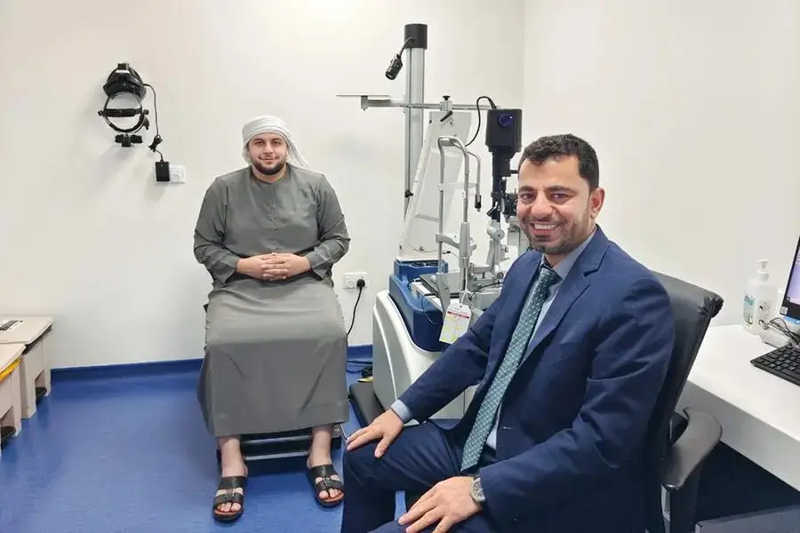 Photo of Dr. Esmaeil Arbabi with happy patient at Moorfields Eye Hospital Abu Dhabi